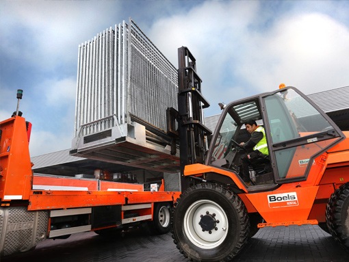 Employee on a telehandler moving equipment
